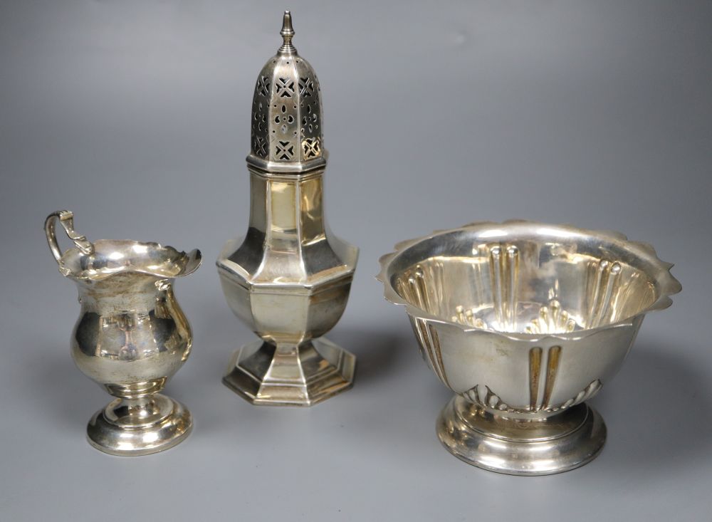 A George V silver sugar caster, later cream jug and Edwardian sugar bowl, 11.5oz.